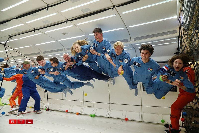 Participants floating in the cabin during a parabolic zero-gravity flight